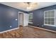 Bedroom featuring hardwood floors, a ceiling fan, a window offering natural light, and an ensuite bath at 2005 Isabela Ct, Summerville, SC 29483