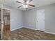 Neutral bedroom featuring hardwood floors, a ceiling fan, and a white paneled door at 2005 Isabela Ct, Summerville, SC 29483