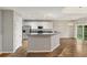 Modern kitchen with stainless steel appliances, white cabinets, hardwood floors, and a breakfast bar at 2005 Isabela Ct, Summerville, SC 29483