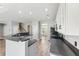 Kitchen features a breakfast bar overlooking an adjacent living room, stainless appliances, and gray countertops at 2005 Isabela Ct, Summerville, SC 29483