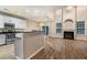 Open-concept room with luxury floors, a fireplace, and adjacent kitchen at 2005 Isabela Ct, Summerville, SC 29483