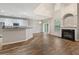 Open-concept living room and kitchen with hardwood floors and a fireplace to cozy up to at 2005 Isabela Ct, Summerville, SC 29483