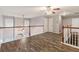 Spacious loft area with hardwood floors, natural lighting, and railing overlooking the lower level at 2005 Isabela Ct, Summerville, SC 29483