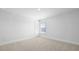 Bright bedroom featuring neutral carpet, white walls, window and white trim at 201 Terrace View Dr, Summerville, SC 29486