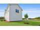 Bright, white home featuring horizontal siding, green lawn, and a newly planted tree at 201 Terrace View Dr, Summerville, SC 29486