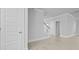 Hallway with multiple doors and a glimpse of a staircase, featuring light-colored wood flooring at 201 Terrace View Dr, Summerville, SC 29486