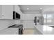 Well-lit kitchen with white cabinets, stainless steel appliances, quartz countertops, and a subway tile backsplash at 201 Terrace View Dr, Summerville, SC 29486