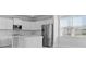 Modern kitchen boasts stainless steel appliances, white cabinetry, and an island with a sink at 201 Terrace View Dr, Summerville, SC 29486