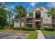 Condo building with brick accents, lush greenery, and palm trees under a blue sky at 2011 N Highway 17 # 1400B, Mount Pleasant, SC 29466