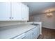 Bright kitchen featuring white cabinetry, stone countertops and stainless steel double sink at 2011 N Highway 17 # 1400B, Mount Pleasant, SC 29466