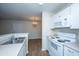 Bright kitchen showcasing white appliances, cabinetry, and an adjacent dining area at 2011 N Highway 17 # 1400B, Mount Pleasant, SC 29466