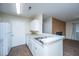 Kitchen with breakfast bar, white cabinets and appliances, and view to fireplace at 2011 N Highway 17 # 1400B, Mount Pleasant, SC 29466