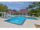 Community pool with clubhouse, lounge chairs and tables under mature shade trees at 2011 N Highway 17 # 1400B, Mount Pleasant, SC 29466