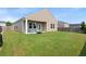 Inviting backyard with well-manicured lawn, fire pit, and covered patio area at 215 Cypress Plantation Rd, Moncks Corner, SC 29461