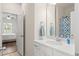 Bright bathroom boasts a modern vanity and open door with a view into an adjacent room with decor at 215 Cypress Plantation Rd, Moncks Corner, SC 29461