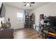 A cozy bedroom with wood floors, filled with shelving and decor under a ceiling fan at 215 Cypress Plantation Rd, Moncks Corner, SC 29461