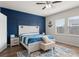 Beautiful bedroom featuring stylish blue accent wall, area rug, and ceiling fan at 215 Cypress Plantation Rd, Moncks Corner, SC 29461