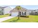 Charming single Gathering home featuring an attached garage, manicured lawn, and beautiful palm tree at 215 Cypress Plantation Rd, Moncks Corner, SC 29461