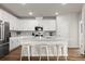 Bright, open kitchen featuring white cabinetry, stainless appliances, and stylish barstool seating at 215 Cypress Plantation Rd, Moncks Corner, SC 29461
