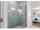 Walk-in shower with blue tiling, built-in shelving and glass door at 215 Cypress Plantation Rd, Moncks Corner, SC 29461