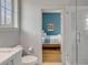 Bathroom view into blue accent wall of bedroom with white tiled shower at 222 Haddrell St, Mount Pleasant, SC 29464