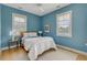 Bright bedroom featuring a wood frame bed, hardwood floors, and a large window at 222 Haddrell St, Mount Pleasant, SC 29464