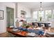 Bright dining area, adjacent to the kitchen, features a table set for dinner with a floral centerpiece at 222 Haddrell St, Mount Pleasant, SC 29464