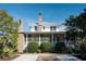 Two-story home with brick chimney, screened porch, and lush landscaping at 222 Haddrell St, Mount Pleasant, SC 29464