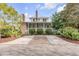 Charming home featuring a spacious front porch, brick chimneys, and a beautifully landscaped yard at 222 Haddrell St, Mount Pleasant, SC 29464