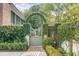 Arched gate covered in vines gives access to the lush backyard at 222 Haddrell St, Mount Pleasant, SC 29464