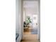 Inviting hallway with hardwood floors, seating, and a glimpse of the bathroom at 222 Haddrell St, Mount Pleasant, SC 29464