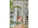Hallway leading to an office area with a view of custom bookshelves and a comfortable orange chair at 222 Haddrell St, Mount Pleasant, SC 29464