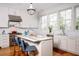 Bright kitchen with marble counters, stainless steel appliances, island with bar seating, and large windows at 222 Haddrell St, Mount Pleasant, SC 29464