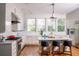 Spacious kitchen featuring stainless steel appliances, an island with bar stools, hardwood floors, and many windows at 222 Haddrell St, Mount Pleasant, SC 29464