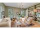 Comfortable living room featuring sage walls, hardwood floors, guitars, and custom built-in bookshelves at 222 Haddrell St, Mount Pleasant, SC 29464