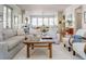Open-concept living room with hardwood floors, neutral-toned furnishings, and view into modern kitchen at 222 Haddrell St, Mount Pleasant, SC 29464