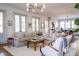 Well-lit living room boasts a sectional sofa with an open layout to the kitchen, complete with shiplap walls at 222 Haddrell St, Mount Pleasant, SC 29464