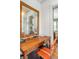 Bright office space with a wooden desk, orange chair, shiplap walls, and a decorative mirror at 222 Haddrell St, Mount Pleasant, SC 29464