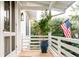 Charming porch featuring a small tree, an American flag, and a picturesque setting at 222 Haddrell St, Mount Pleasant, SC 29464