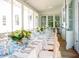 Elegant screened porch featuring a long table adorned with glassware and flowers at 222 Haddrell St, Mount Pleasant, SC 29464