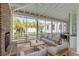 Comfortable screened porch with stylish seating, brick fireplace and view of backyard at 222 Haddrell St, Mount Pleasant, SC 29464