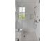 Modern shower with white tile, glass enclosure, and hexagon tile floor at 222 Haddrell St, Mount Pleasant, SC 29464