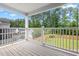 Outdoor porch area with a view of a fenced backyard and lush green trees at 234 Cameron St, Summerville, SC 29486