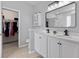A modern bathroom features double sinks and a spacious walk-in closet at 234 Cameron St, Summerville, SC 29486
