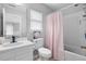 Bright bathroom featuring a white vanity and a shower-tub combination with pink polka dot curtain at 234 Cameron St, Summerville, SC 29486