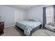 Carpeted bedroom showcasing a double-door closet, window with curtains, and comfortable seating at 234 Cameron St, Summerville, SC 29486