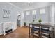Bright dining room featuring light grey walls and trim, a dining table, and built-in cabinets at 234 Cameron St, Summerville, SC 29486