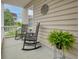 Inviting front porch featuring rocking chairs and a beautiful fern, perfect for relaxing at 234 Cameron St, Summerville, SC 29486