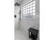 A luxurious shower features rainfall showerhead and a glass block window for natural light at 234 Cameron St, Summerville, SC 29486