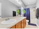 Bathroom featuring dual sinks, wood vanity, and tub with shower, providing functionality and style at 252 Island Green Rd, Goose Creek, SC 29445